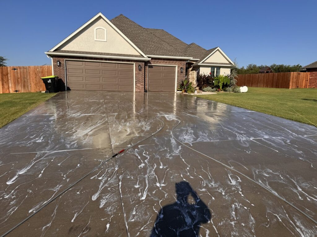Pressure washed driveway with foam treatment at OKC home